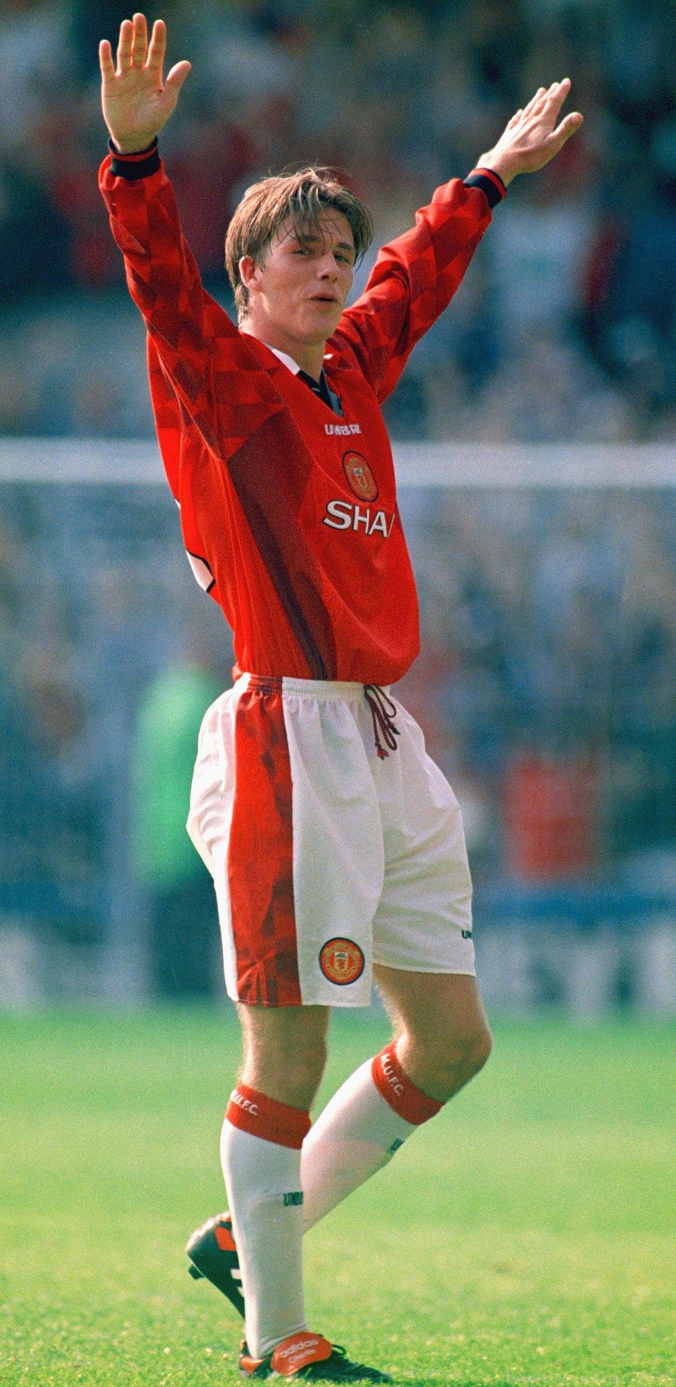 Manchester United player David Beckham celebrates after scoring the third goal against Wimbledon with a spectacular effort from the halfway line in 1996