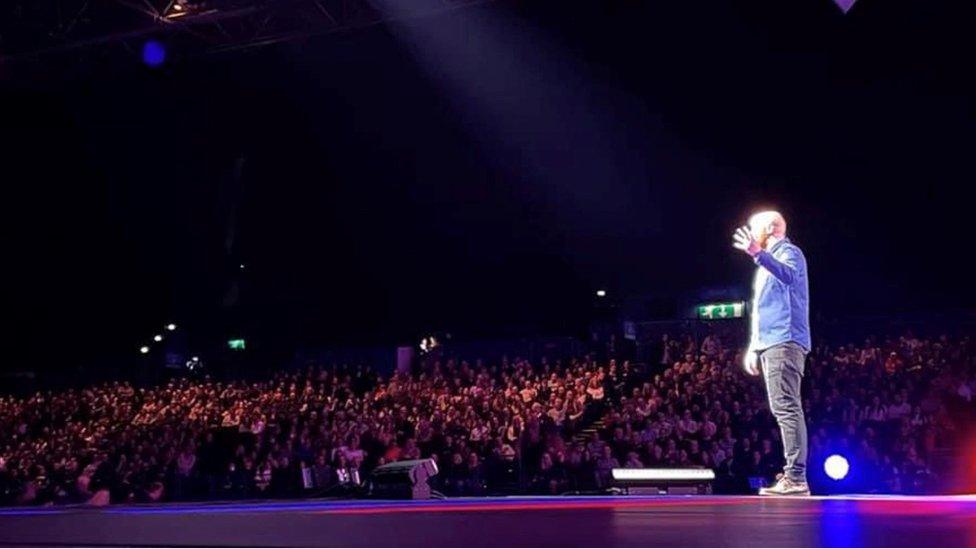 Ray Bradshaw performing comedy on stage