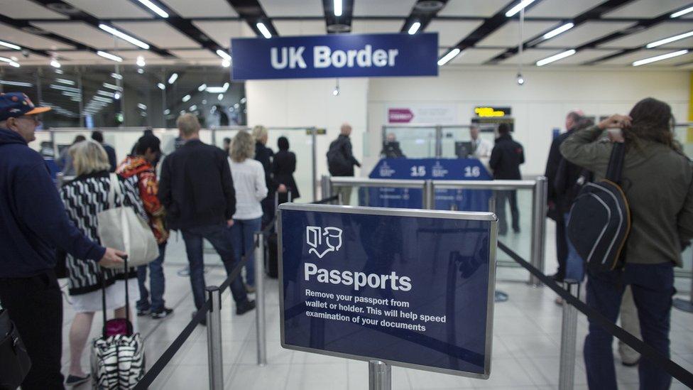 Border Force check the passports of passengers arriving at Gatwick Airport