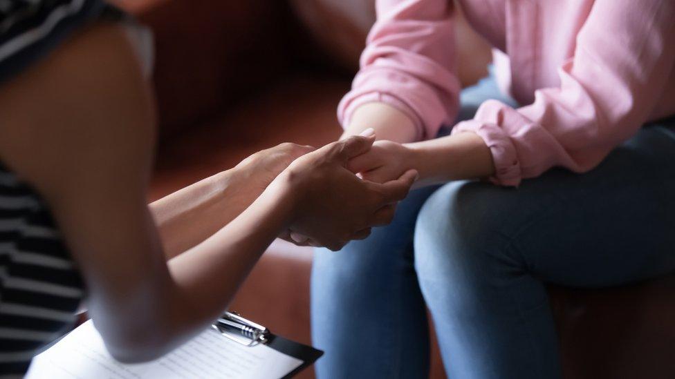 Therapist holding a woman's hands