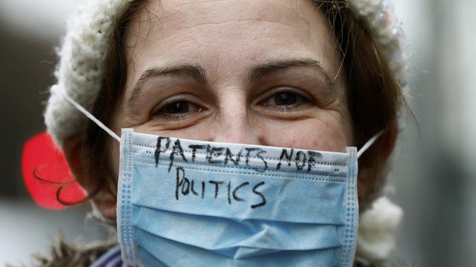 Junior doctor with slogan on her mask