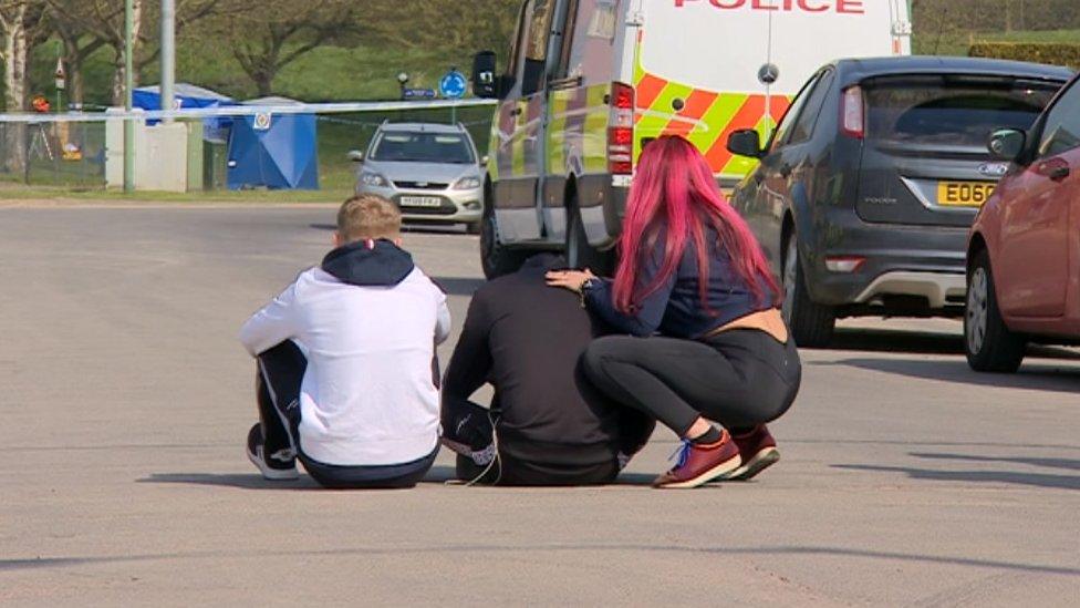 Mourners at the scene on Arran Way