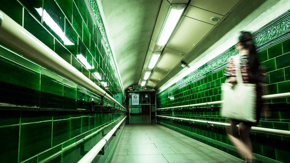 Blurred image of a woman in a deserted subway