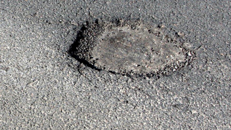 Potholes in road