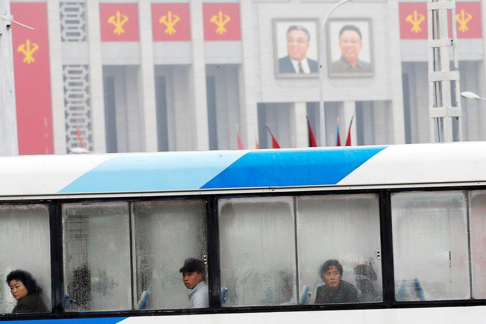 People look on from inside of a trolleybus as it passes by the venue of a ruling party congress in Pyongyang, North Korea 6 May 2016