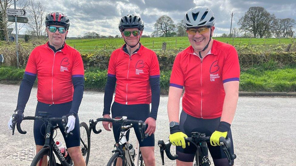 Three men on bicycles