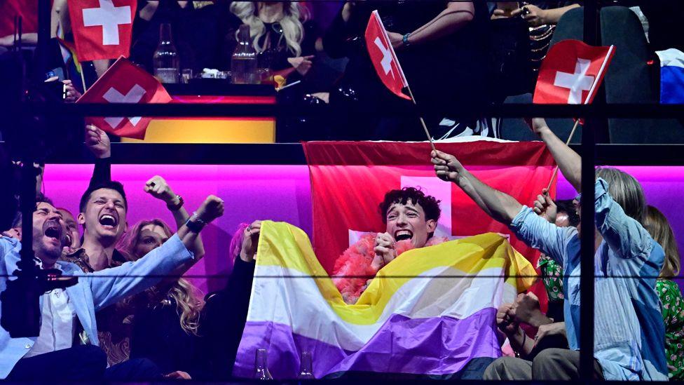 Switzerland's Eurovision winner Nemo and supporters celebrate with non-binary flag