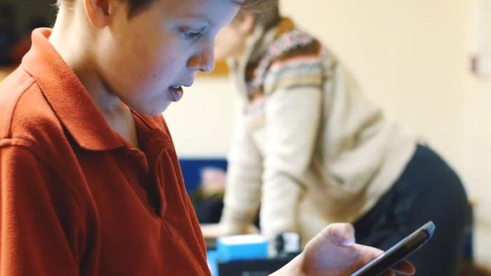 child plays with 5G handset