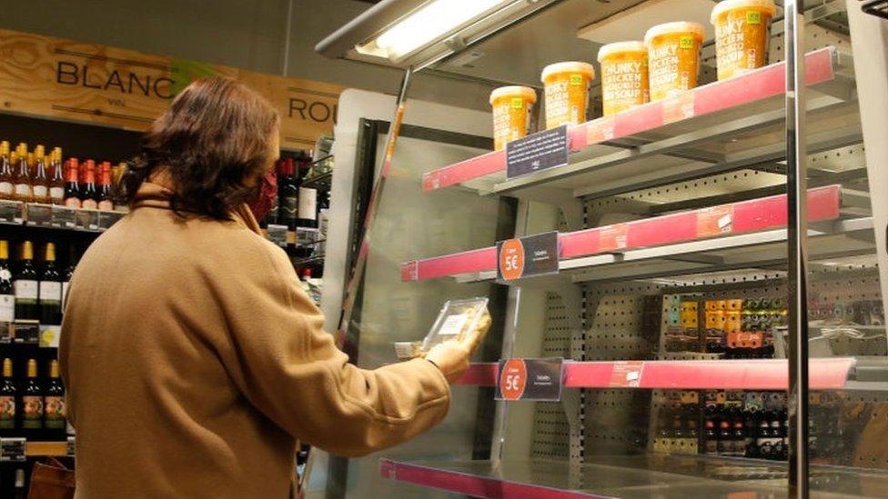 Woman looking at goods in M&S store in Paris