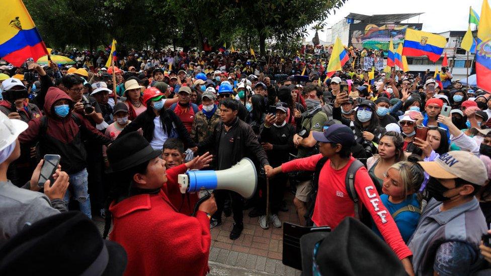 Image shows man addressing protesters