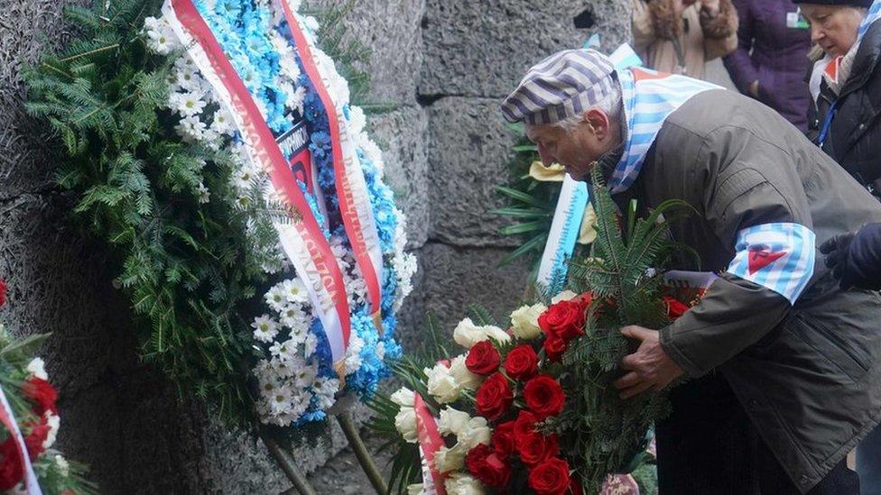 Survivors and other guests attend a wreath-laying ceremony