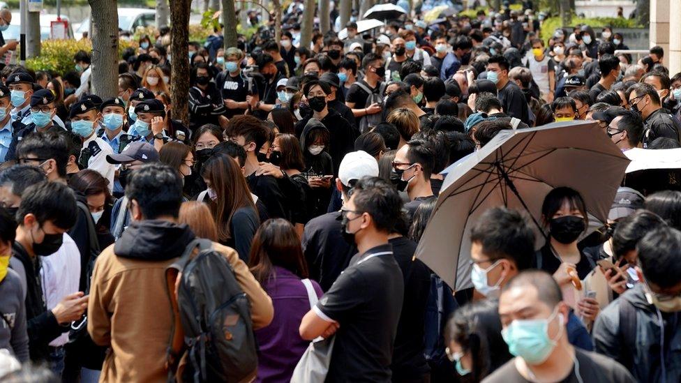 Supporters of pro-democracy activists gather outside West Kowloon Magistrates' Courts for a hearing over charges related to national security, in Hong Kong, 1 March 2021