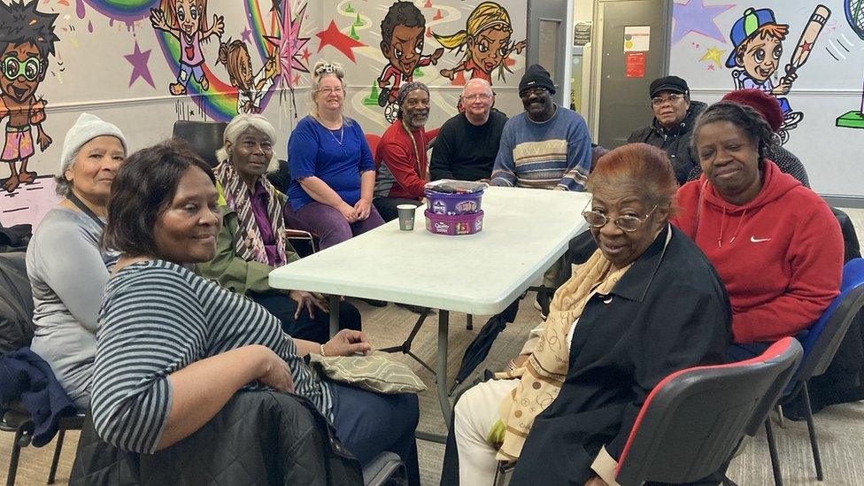 A group of older people sitting around a table in a leisure centre