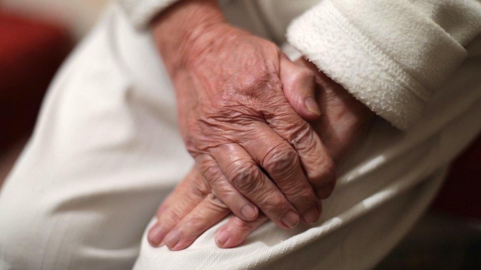 Man holding his hands on his leg