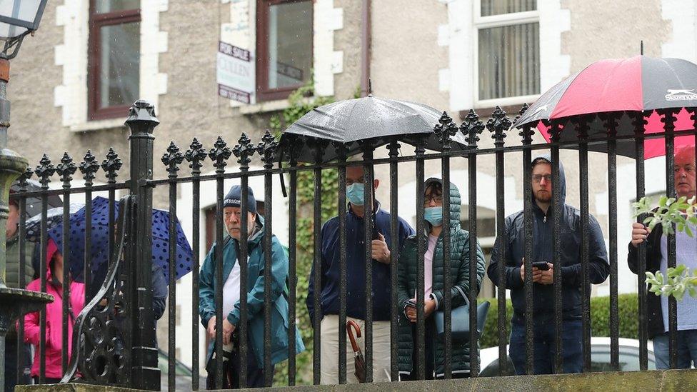 People gathered at the gates of St Eugene's Cathedral to pay their respects to John Hume