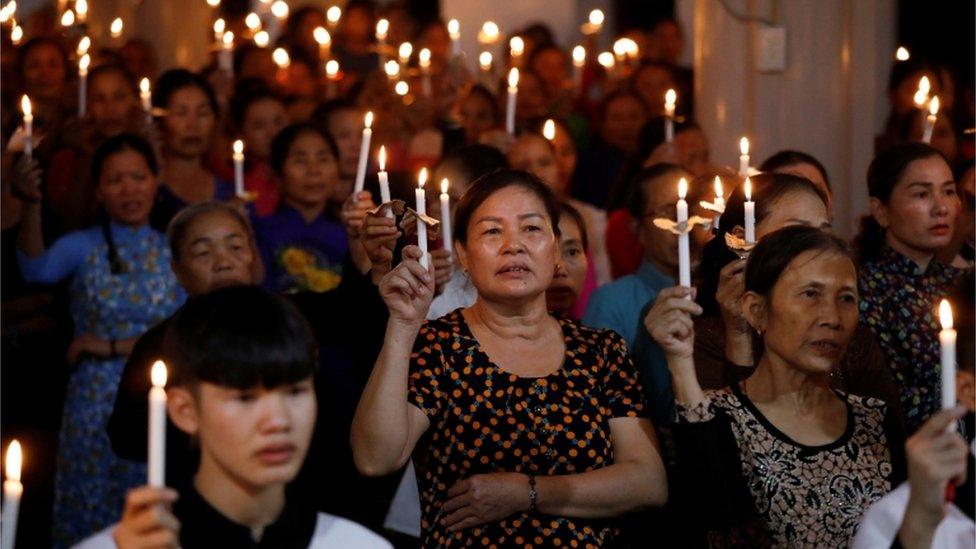 Worshippers with candles