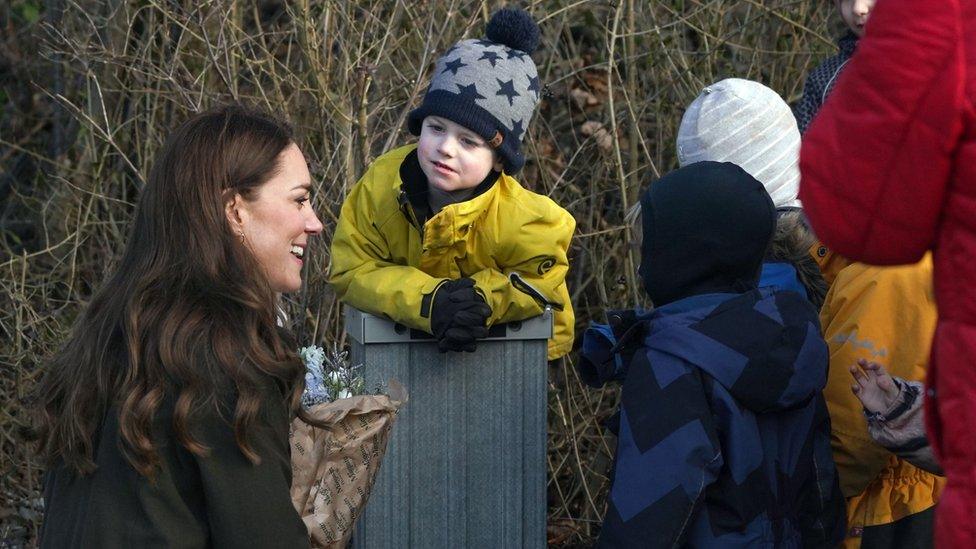 The Duchess of Cambridge speaks with pupils at an outdoor school