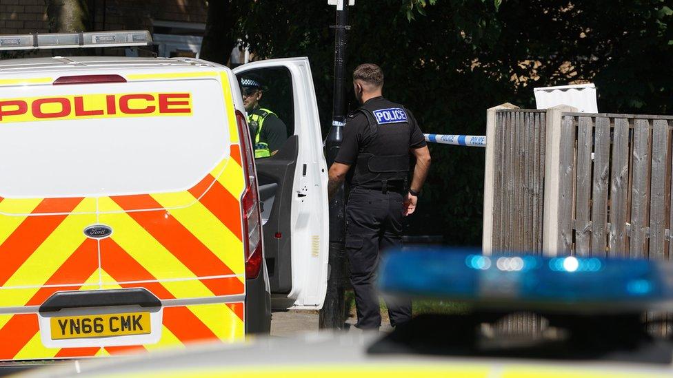 Officers at the scene following the death of a man in Sheffield