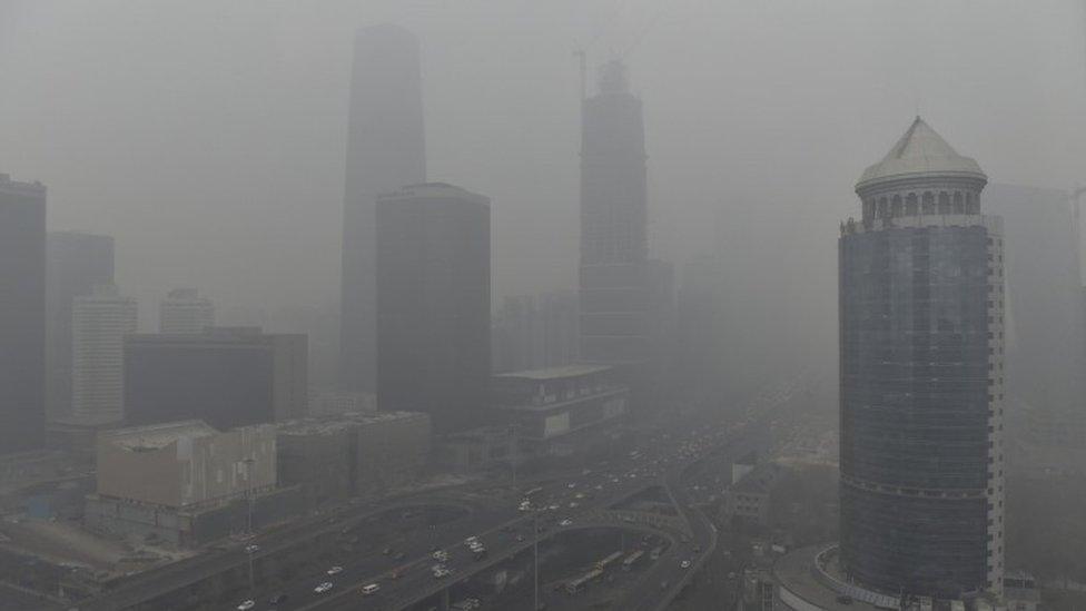 Vehicles travel on the Guomao bridge (bottom L) as the Central Business District (CBD) area is seen amid heavy smog after the city issued its first ever "red alert" for air pollution, in Beijing, China, December 8, 2015