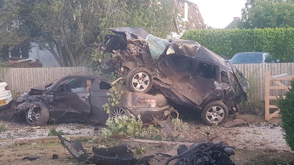 Two of the cars crashed through Mr Pearce's driveway before before igniting
