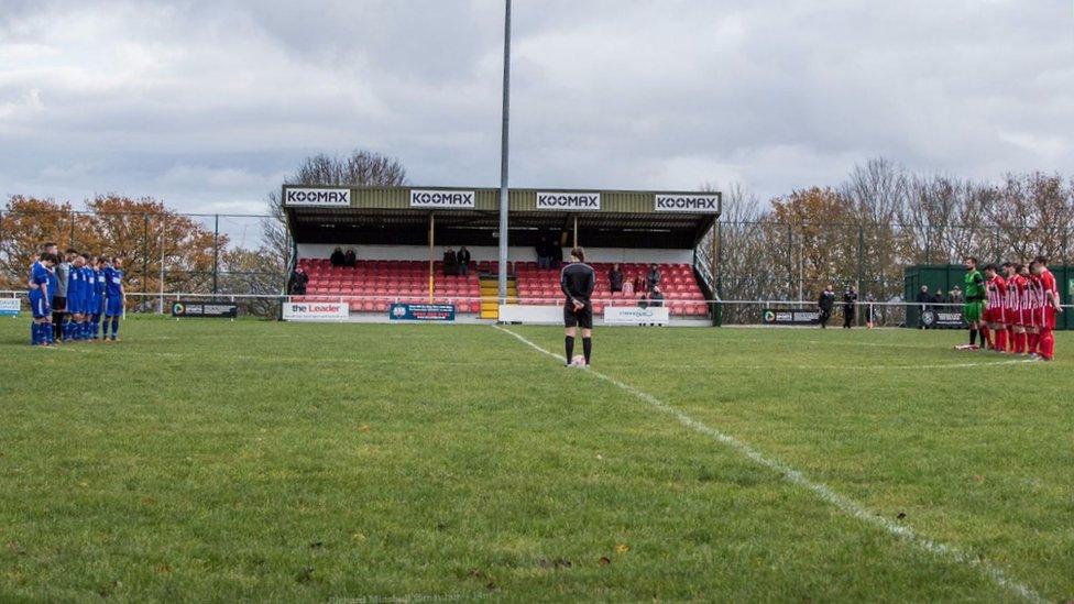 FC Nomads (blue) held a minute's silence for their former president