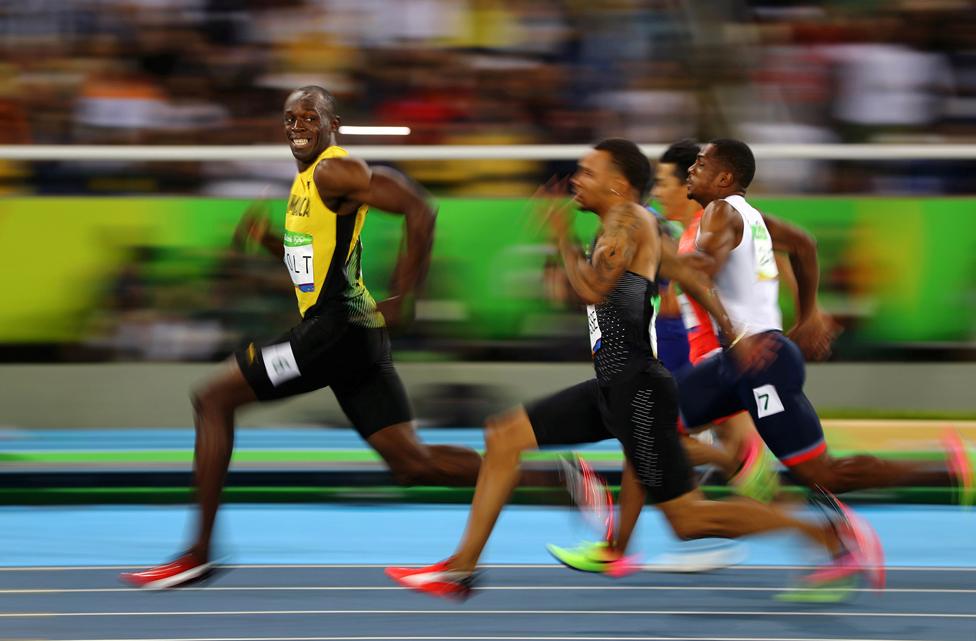 Usain Bolt of Jamaica smiles as he looks back at his competition, whilst winning the 100-meter semi-final sprint, at the 2016 Olympics in Rio de Janeiro, Brazil