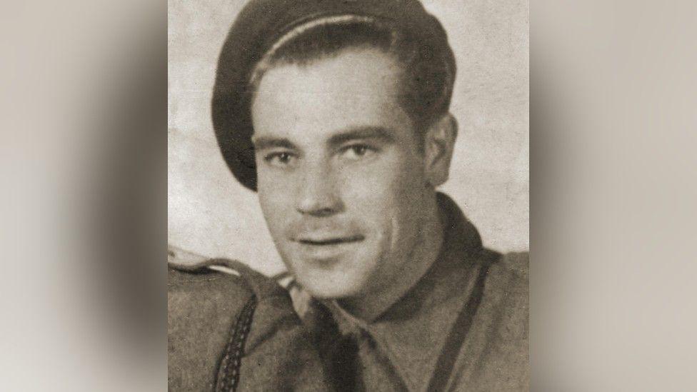 An old black and white photograph of Alfred Ernest Latham. He is wearing an SAS uniform, including a cap. He is looking direct into the camera.