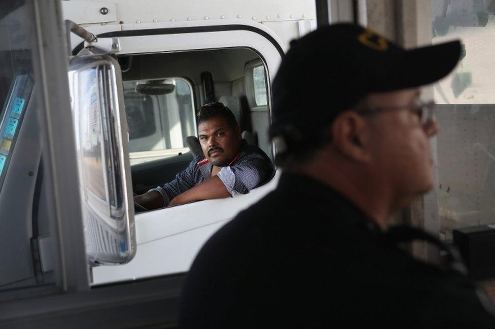 A Mexican trucker waits while a U.S. Customs and Border Protection officer processes import documents on October 17, 2016 in Laredo, Texas.