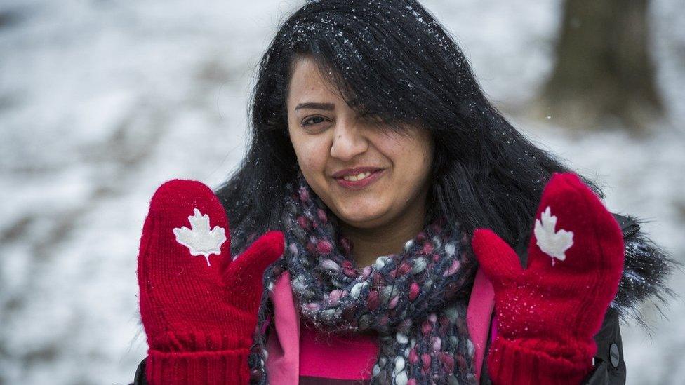 Syrian refugee Rania Alhasan smiles and holds up her Canadian themed mittens in Mississauga, Ontario, Canada, Thursday January 21, 2016.