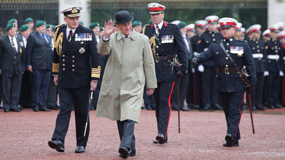 Prince Philip braved torrential rain outside Buckingham Palace