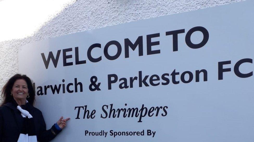 Elizabeth Orras with the Harwich & Parkeston FC sign