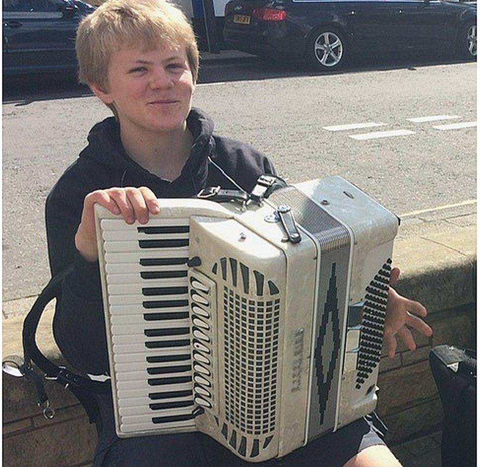 Harris playing his accordion