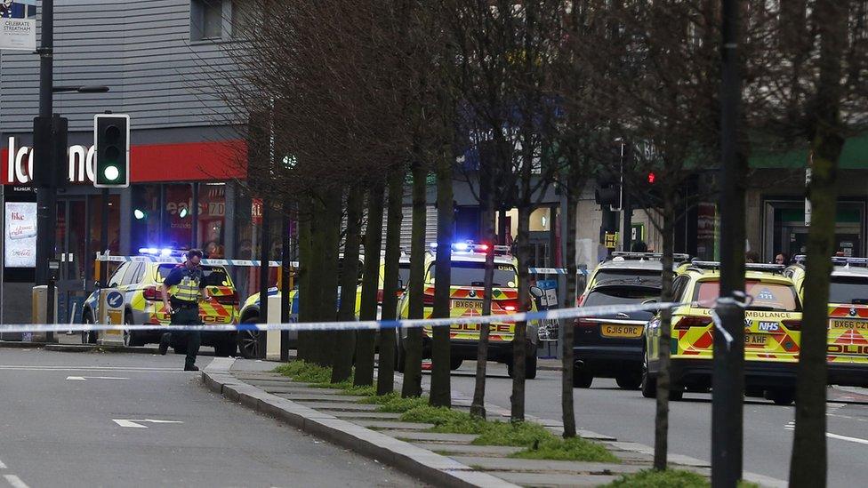 Police officers at the scene after a man was shot and killed by armed police