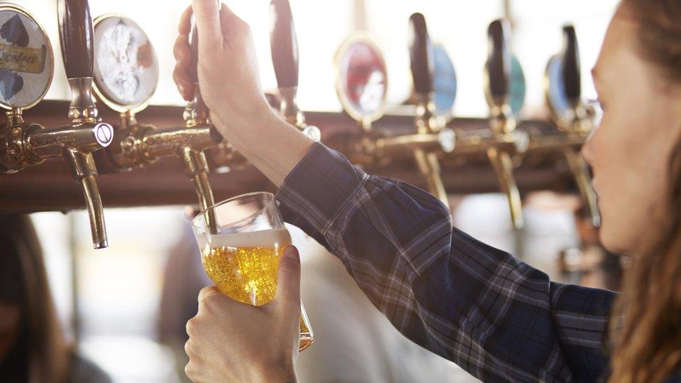 woman pouring a pint