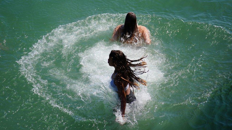 People swimming at Brighton beach.