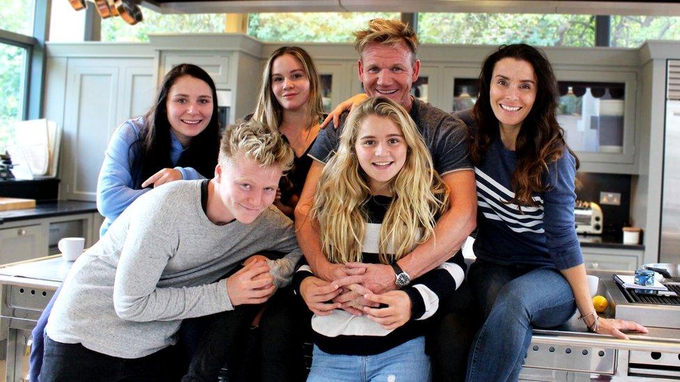 tilly with her family in a kitchen