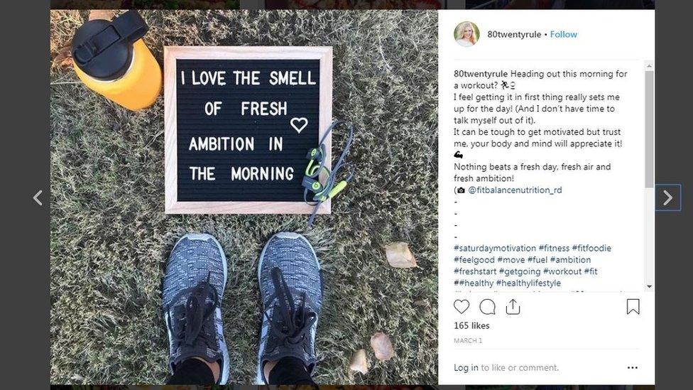 Running shoes next to a water flask and a sign that reads 'I love the smell of fresh ambition in the morning'