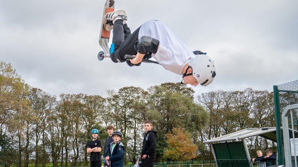 Boy on a scooter using new skate park