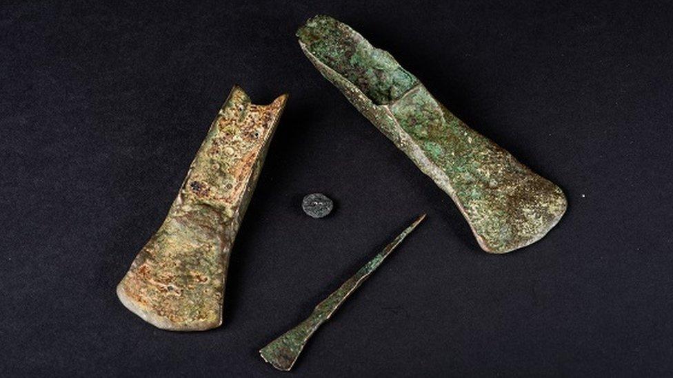 The Holme Bronze Age beach finds, two palstaves (axes), a chisel and a button