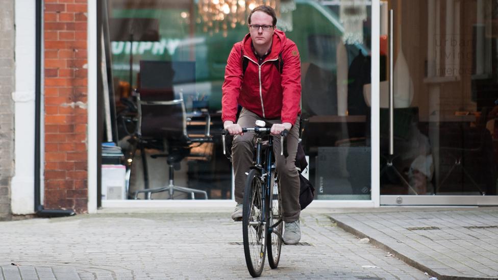 Tim Johns cycling through central London