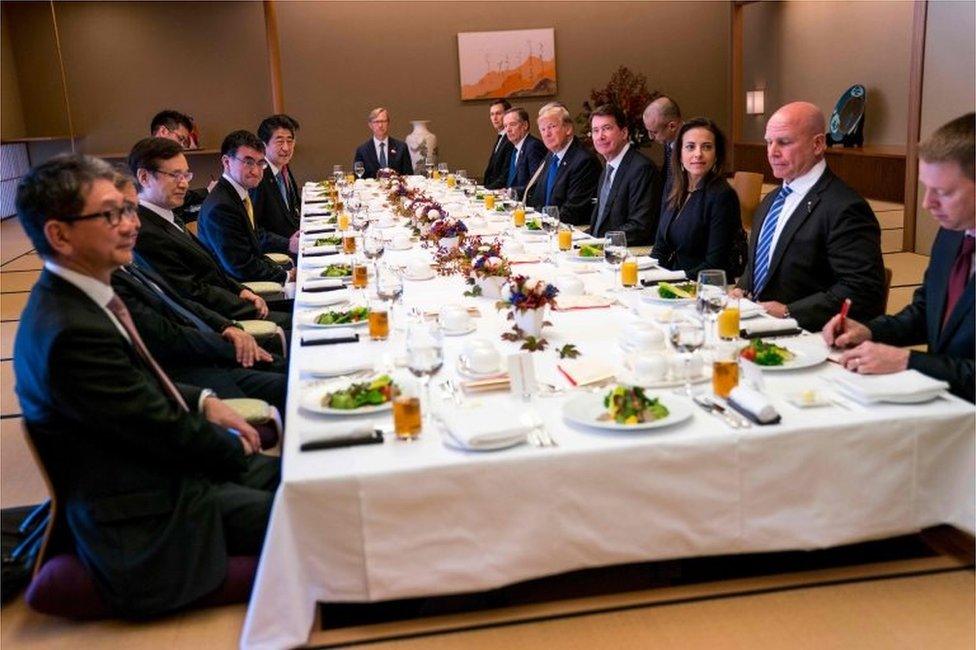 US President Donald Trump (5th R on table) and Japan's Prime Minister Shinzo Abe (5th L on table attend a working lunch at the Akasaka Palace in Tokyo on 6 November 2017.