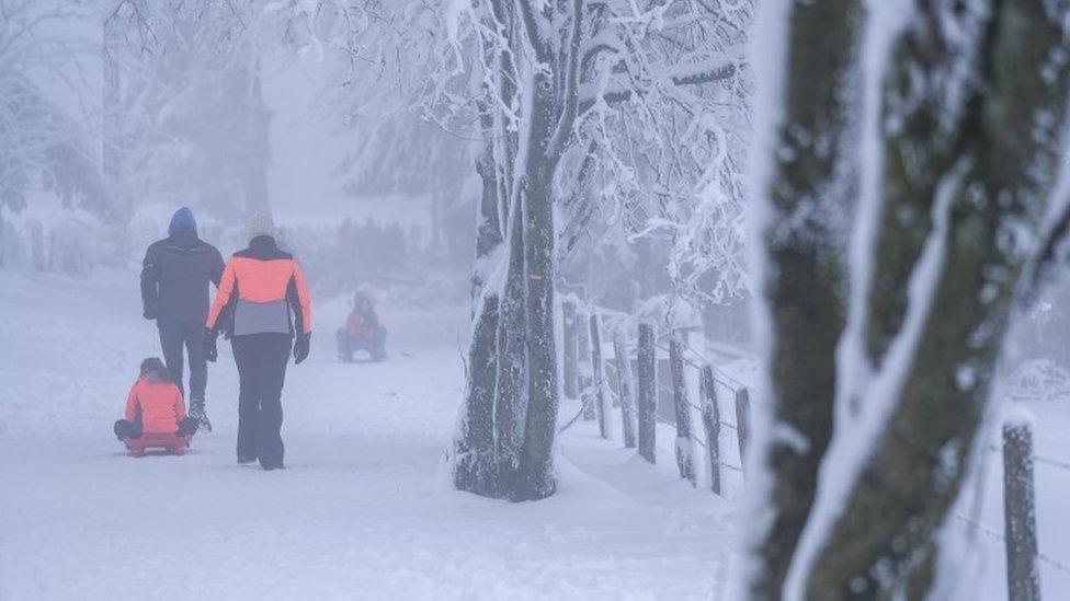 Famillies enjoy the snow near the "Baraque de Fraiture", in the Ardennes, Belgium, 09 January 2021.