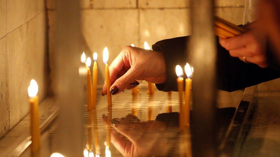 A person lighting up candles