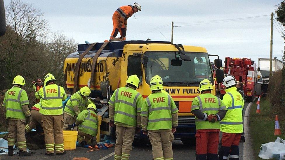 Oil tanker with firefighters at the scene