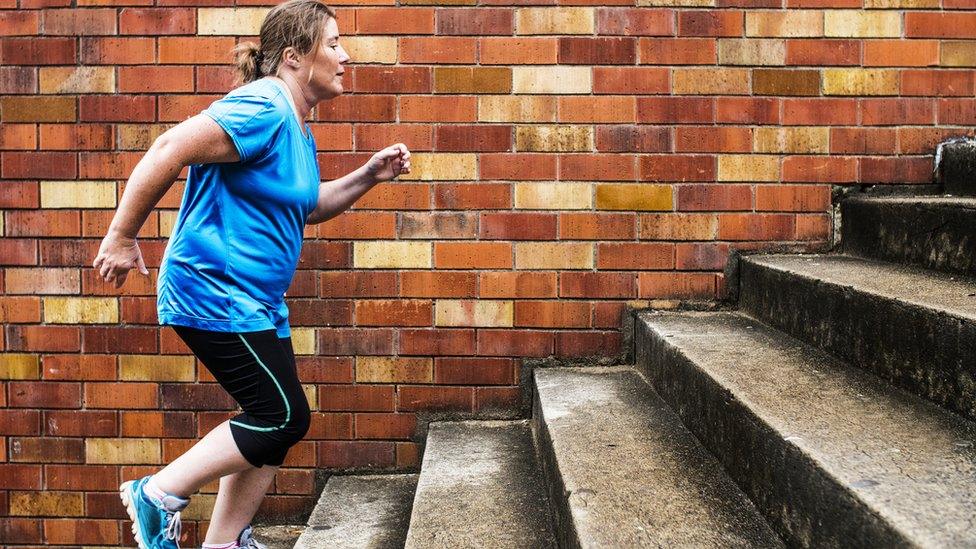 Woman running up steps