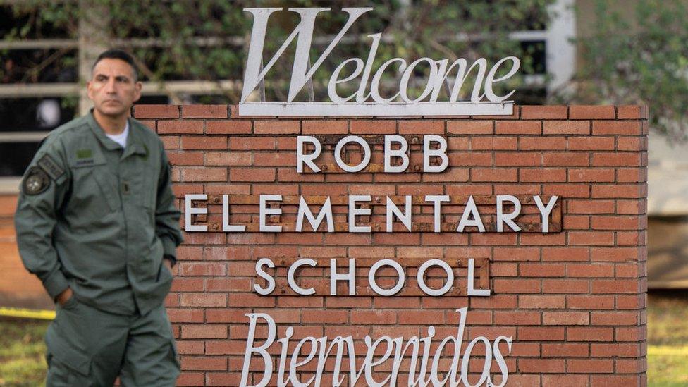 A law enforcement officer stands outside Uvalde middle school