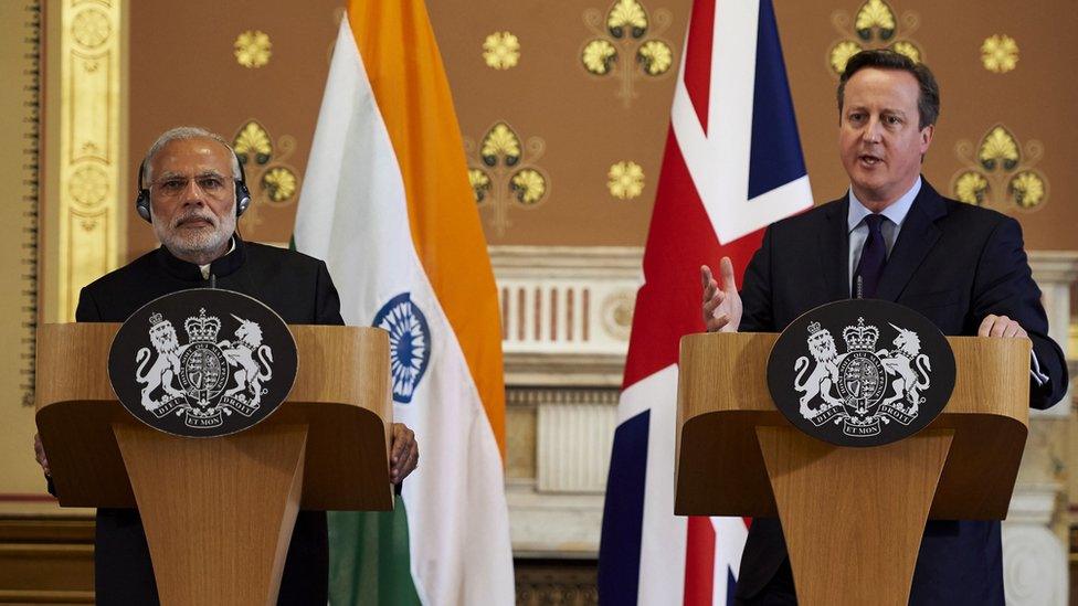 Mr Cameron speaking alongside Mr Modi in front of the Indian and Union Jack flags