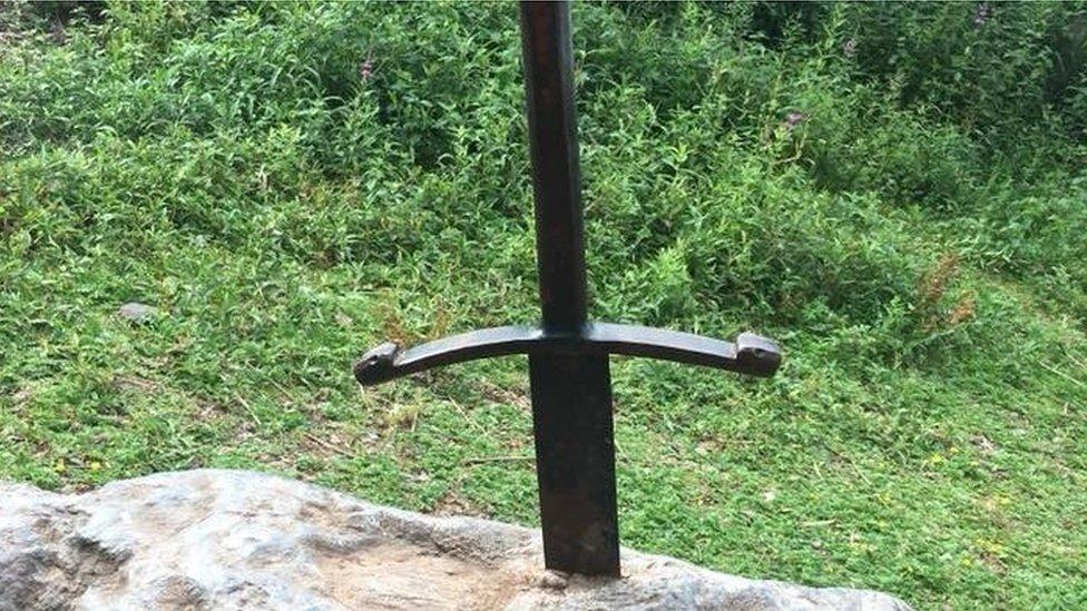 A photo of the Excalibur sword placed in the stone.