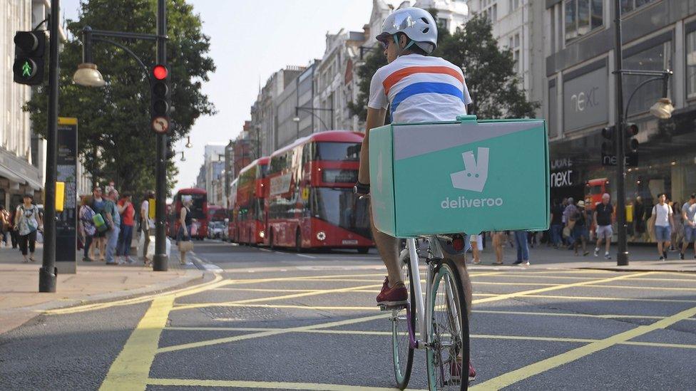 A cyclist delivering food for Deliveroo