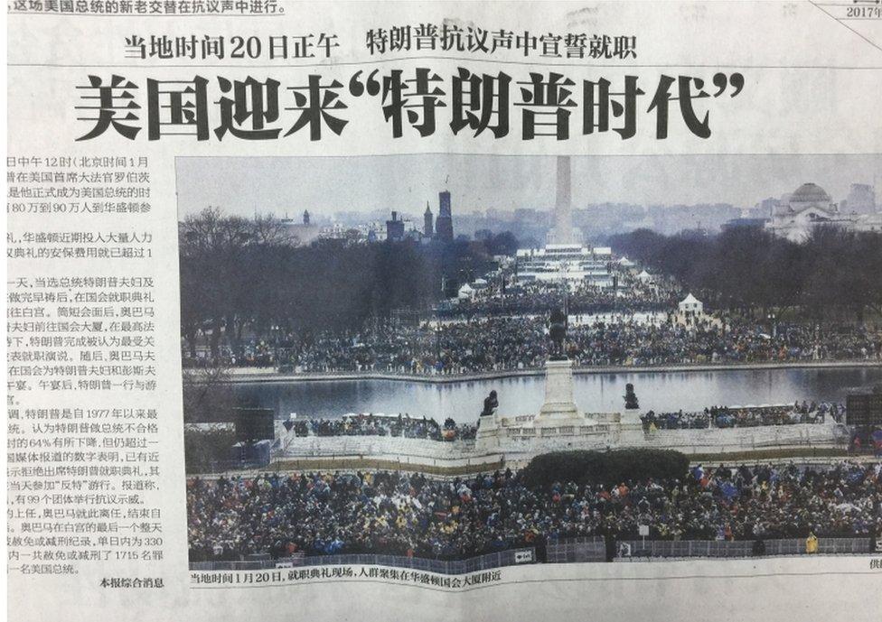 A photograph of a Chinese newspaper front page, showing a picture from Donald Trump's inauguration.